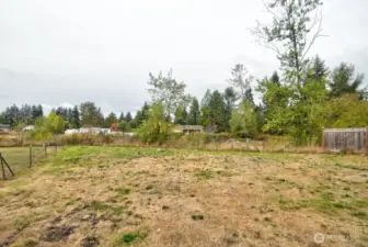 Large lot with green belt behind.