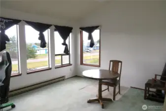 THE LVING ROOM HAS A FULL BANK OF WINDOWS FACING WEST FOR A PEEK-A-BOO VIEW OF THE PACIFIC OCEAN!