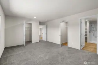 Primary bedroom with multiple walk-in closets and a spacious bathroom awaits