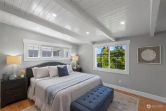 The serene main floor primary bedroom overlooks the Harbor and side yard.  The remote-controlled main window shade offers top-down, bottom-up coverage for adjustable privacy. Dimmable overhead lighting and hardwood floors complete the cozy look.