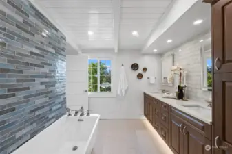 This spa-like primary bath will delight you with a long soaking tub, decorative tile, dimmable overhead lights, heated floors, under cabinet lighting and lighted mirrors.  Quartz countertop & lots of storage. There's even a view of the Harbor and pickleball court!