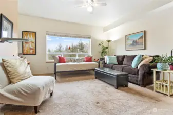 Spacious living room with views out the large picture window.