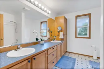 Primary bathroom is so spacious and includes double sinks and a large shower. Overlooks the pretty backyard.