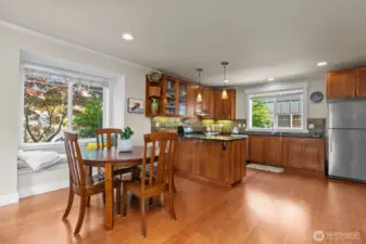 Dining area features sunny reading nook.