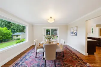 The formal dining room showcases the pristine yard and brings the outdoors in.
