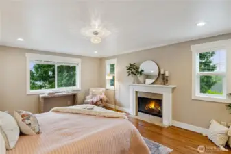 Very spacious primary bedroom with wood-burning fireplace and walk-in closet.
