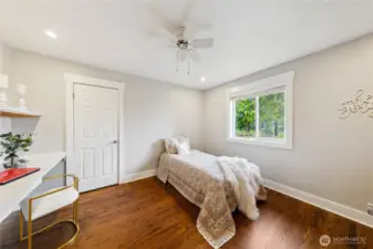 Upstairs bedroom with walk-in closet, built-in desk and shelf.