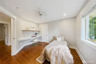Upstairs bedroom with cedar lined walk-in closet and built-in desk and book shelf.