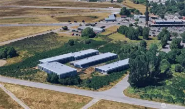 This is a screenshot from a satellite-geo-imaging software of the parcel, which has then been digitally altered to have AI generated buildings laid out onto the parcel. The AI-generated buildings on the property do not reflect what is actually on the property, and do not reflect any civil engineer's drawing. The buildings are merely generated with AI. This is vacant land.