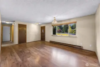 View from additional living space to main entry and hallway to bathroom and bedrooms