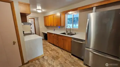 Another view of the kitchen from its eating nook area