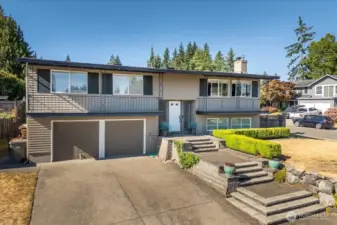 Artful and pristine landscaping greets you every time you pull into the driveway.