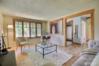 The elegant wood millwork beautifully frames the open view from the living room to the entryway, adding a touch of sophistication and seamless flow between spaces.