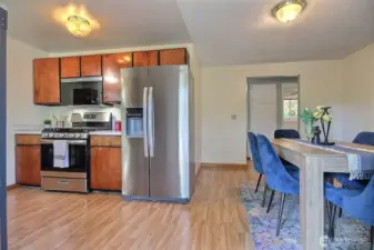 Kitchen features newer stainless steel appliances and gas stove.