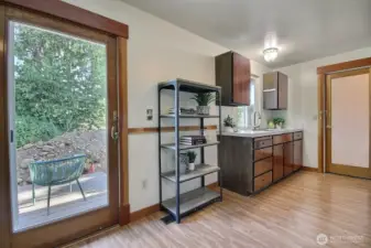 Step outside with ease through this lovely glass door, leading you to a charming deck perfect for outdoor dining, relaxing, and entertaining.