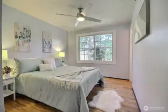 Another view of the primary bedroom-bright with abundant natural light and stylish ceiling fan!