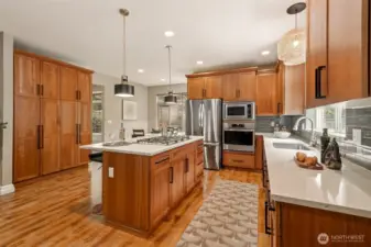 The quartz counters highlight the kitchen with it's wonderful maple cabinets and stainless steel appliances.