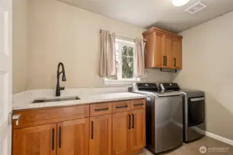 Even the upstairs utility room was updated with its quartz counters and the washer and dryer stay!