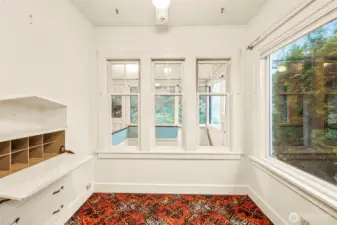 Your breakfast nook or cozy reading area. Love the vintage built-ins!