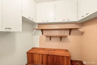 Storage abounds in the potential mudd room.