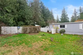 Flower garden area in the back with 3 sheds