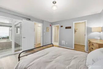 View to patio off primary bedroom, walk in closet and bathroom doorway.