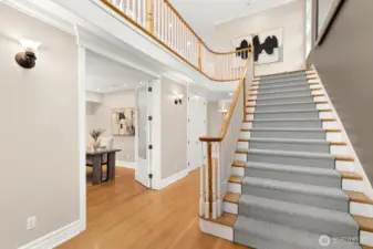 The gracious entry way leads you up to the living areas. The main floor office is located to the left in this photo and down the hall, you'll find the three main level bedrooms.