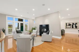 The french doors lead to one of two large decks. The entrance to the kitchen and flex room are pictured to the right here.
