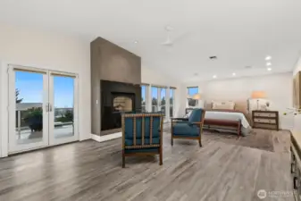 This room has it's own gas fireplace and walls of windows to take in the views. Complete with it's own sitting area too!