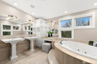 Primary 5-piece bath has extra storage as well as vanity seating.