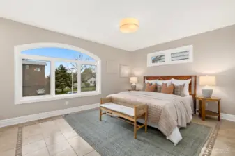 The third bedroom on this level is also considered the second primary suite. The largest bedroom has a desk nook off to the left in this photo and looks west. Two closets and it's own attached full bath!