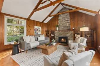 Notice the full height stone chimney facade and vaulted ceilings