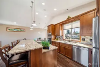 Indulge in culinary delight within this truly lovely kitchen, boasting beautiful custom cabinetry, sleek stainless steel appliances, luxurious slab countertops, mood lighting, and decorative backsplash.