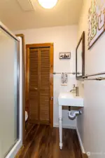 an updated bathroom with a good size storage closet.