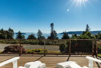 View from deck chairs.  The deck is length of front of home.  Plenty of space for outdoor furniture.   Home is situated on a cul-de-sac.  The way the neighboring homes are situated the deck does offer a sense of privacy.