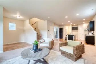 The airy and open floor plan creates a seamless flow and clear sight lines from the living and dining spaces to the kitchen.