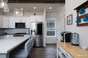 View in kitchen with pantry door to the right of photo and door to the lower level of the home featured next to the window.