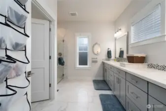 Beautiful expansive spa like primary bedroom bath with solid surface countertops, double sinks, separate toliet room and large walk in shower. Beautiful tile floors and once again lots of natural light.