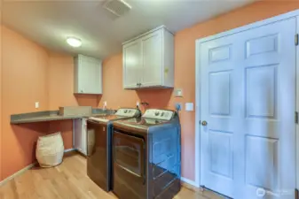 Come in through the 3-car garage to this well-equipped laundry room.