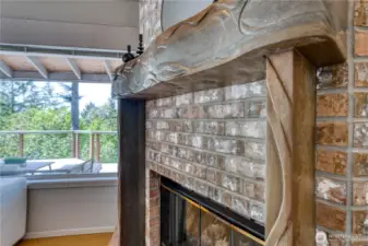 This gas fireplaces has a custom carved stone mantel created by a local artisan.