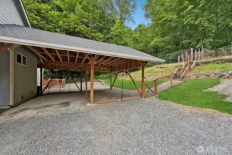 Close up of carport showing stairs up to chicken coop.