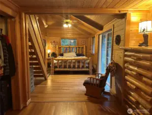 Master bedroom with access to back patio, stairs lead to loft/office.