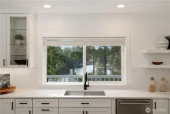 A gourmet kitchen with a western lake view.