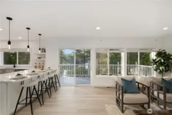 Spacious casual room with gas fireplace adjoins the gourmet kitchen with a wall of west facing windows to capture the view of the lake.
