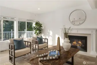 Spacious casual room with gas fireplace adjoins the gourmet kitchen with a wall of west facing windows to capture the view of the lake.