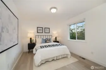 Secondary bedroom #1 (upstairs) overlooks the glistening lake to the west.