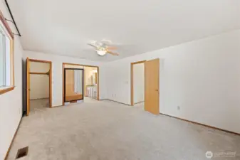 Primary bedroom with walk in closet, jetted tub, and sliding glass door to the deck.