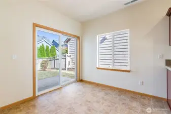 Dining area with slider to fully fenced back yard