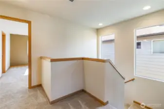 Upstairs landing with primary bedroom to left