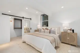 Third bedroom downstairs with vaulted ceilings and a walk in closet.